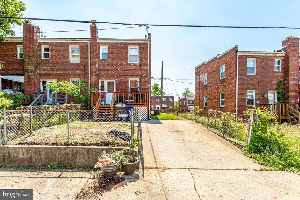 A red brick building with a garden in front.