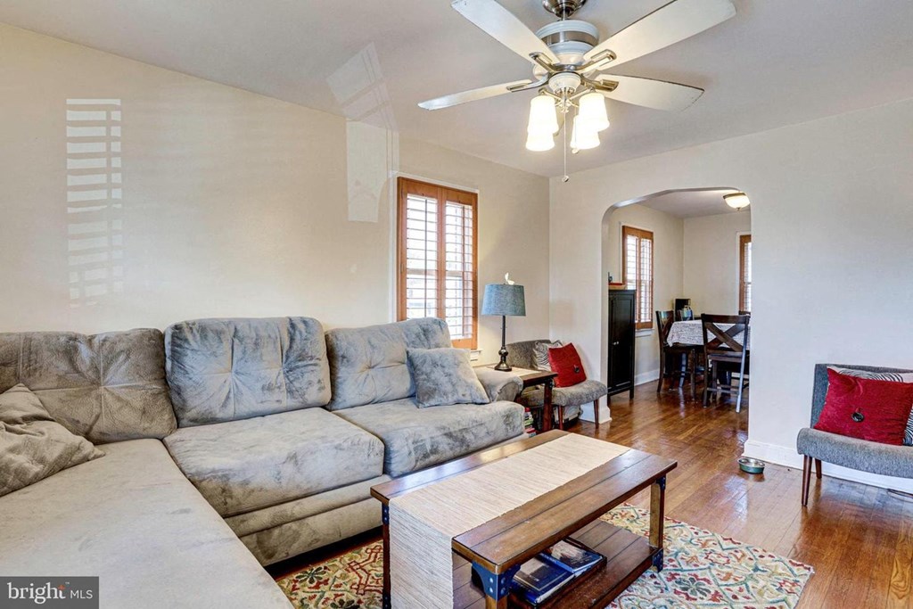 A living room with a grey sofa and a wooden coffee table.