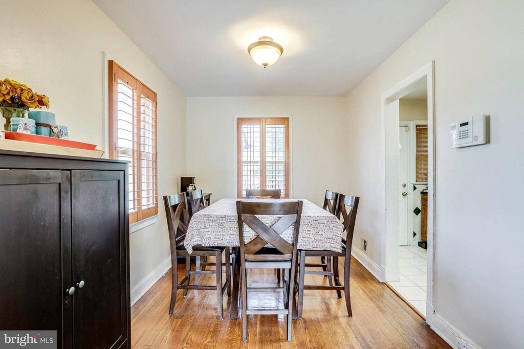 A dining room with a table set for six.
