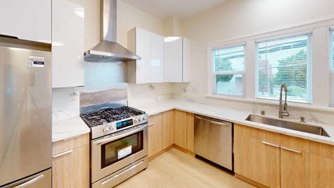 a kitchen with wooden cabinets and stainless steel appliances
