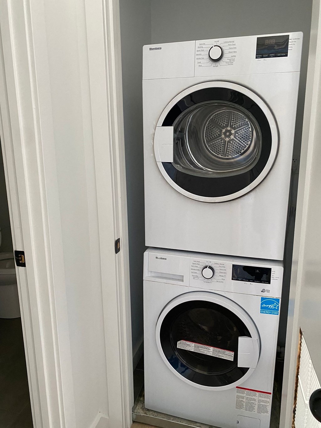 A white dryer is on top of a white washer.
