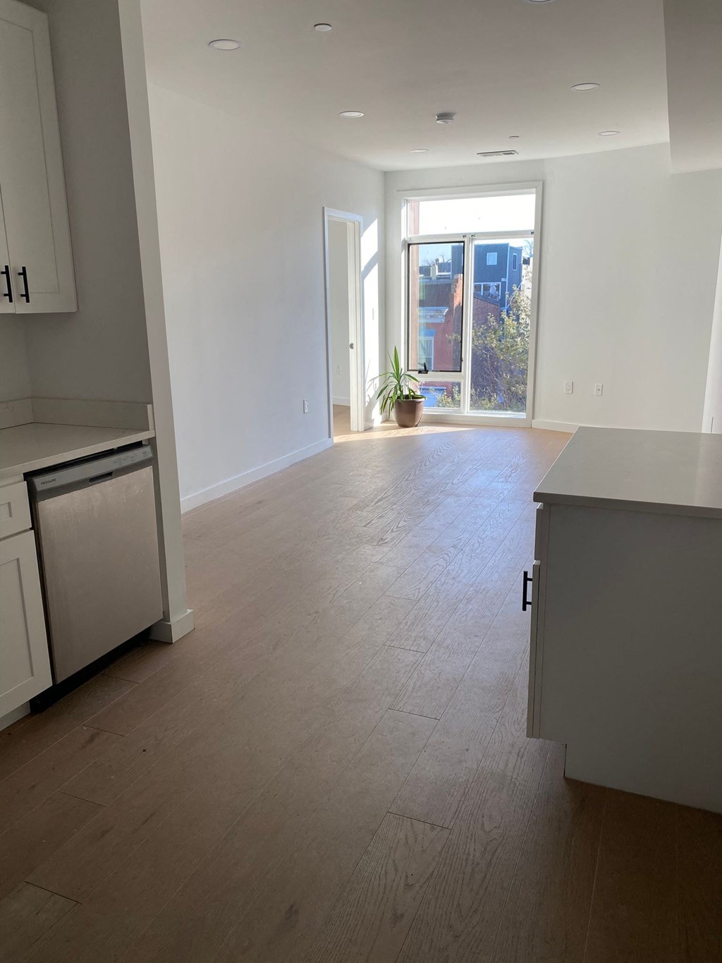 A kitchen with white cabinets and a dishwasher.