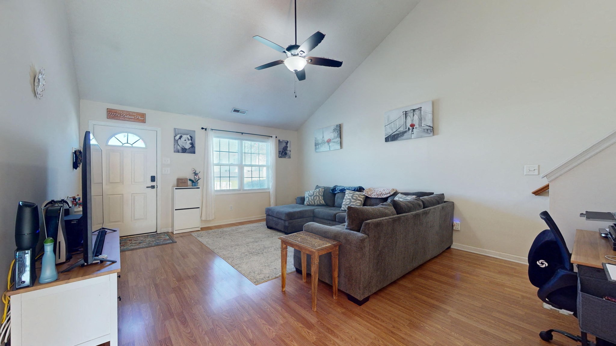 a living room with a couch and a ceiling fan