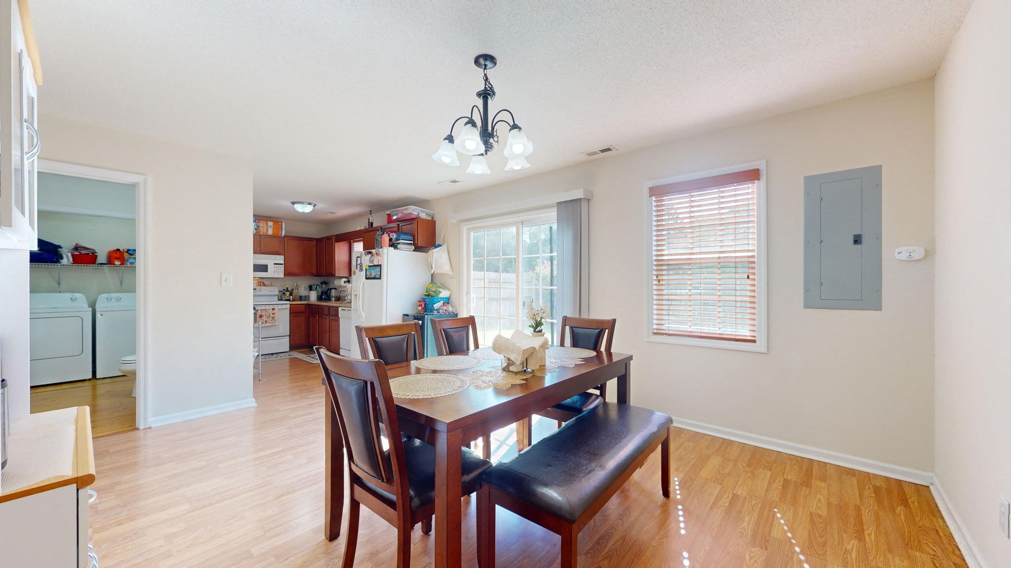 a dining room and kitchen with a table and chairs