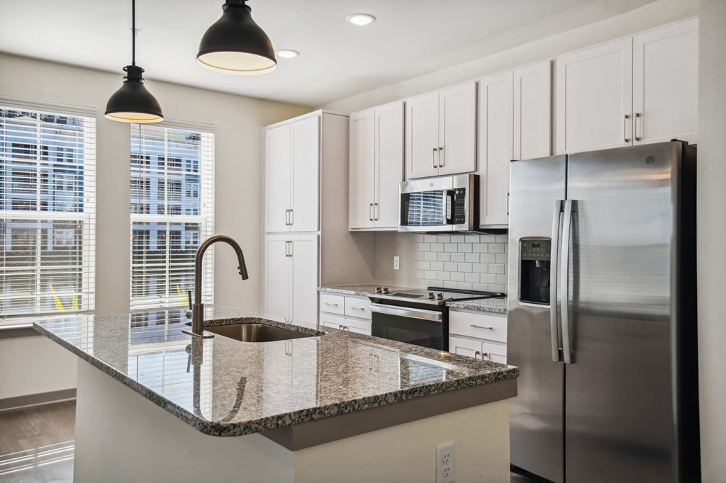a kitchen with granite counter tops and stainless steel appliances