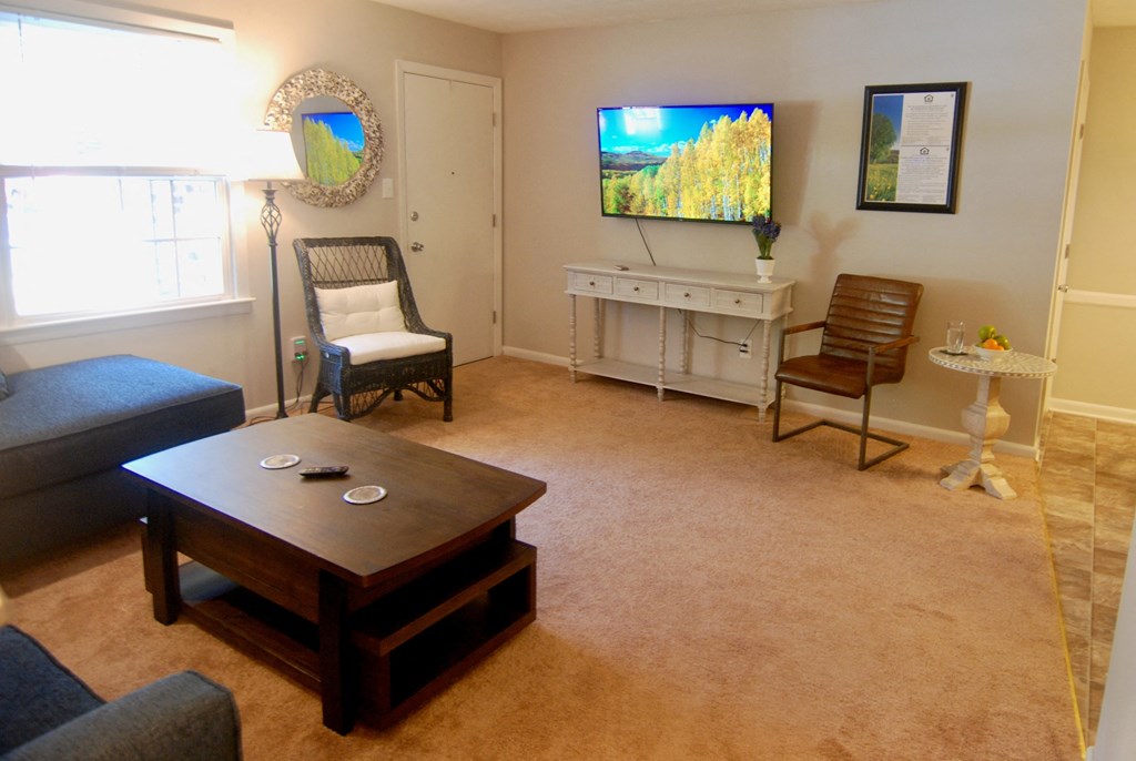 A living room with a television and a chair.