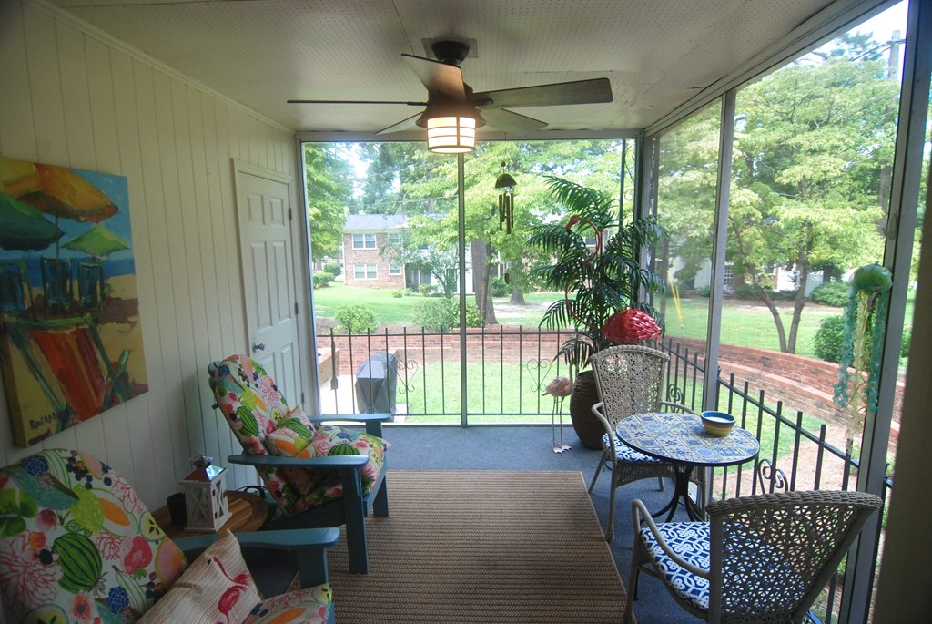A sunny patio with a table and chairs.