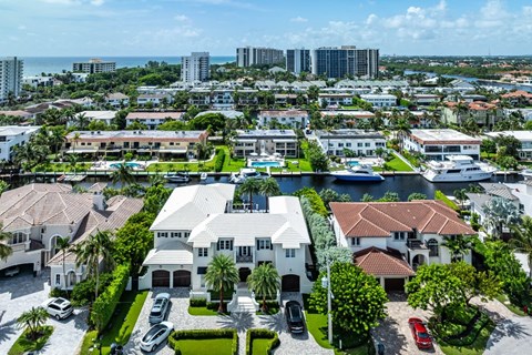 an aerial view of a neighborhood of houses and boats in the water