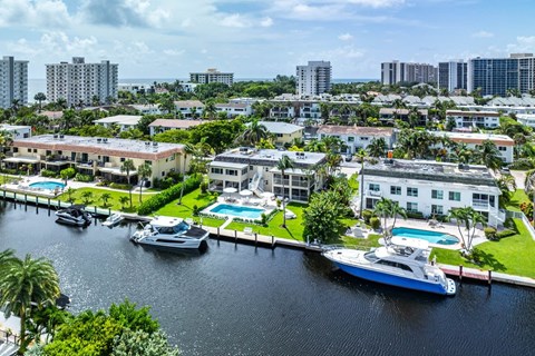 an aerial view of boats docked in a marina with buildings in the background