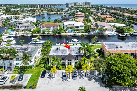 an aerial view of a house with a red arrow pointing to the water