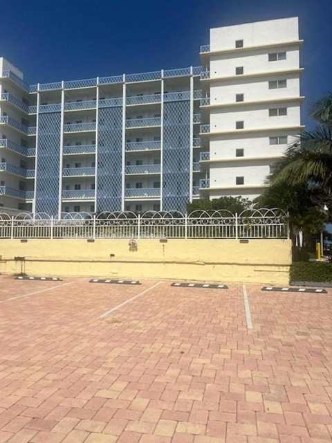 an empty parking lot in front of an apartment building