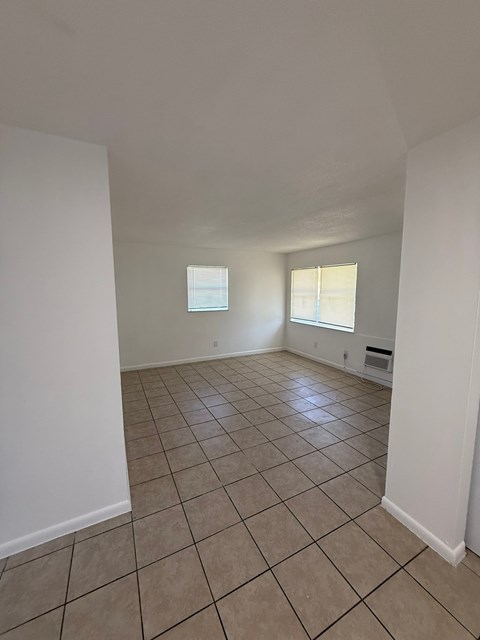 A room with white walls and tile flooring.