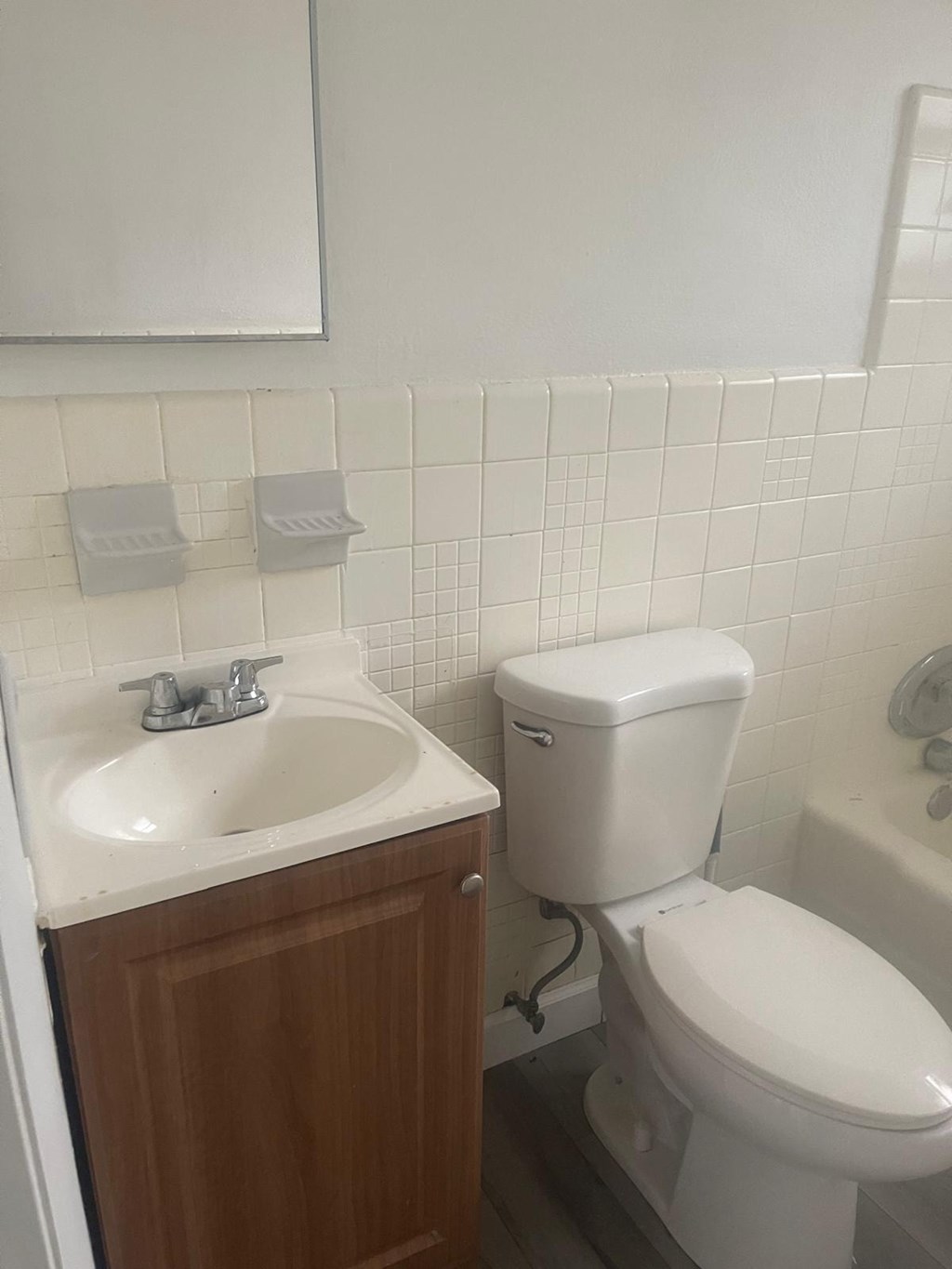 A white toilet sits next to a sink in a bathroom.