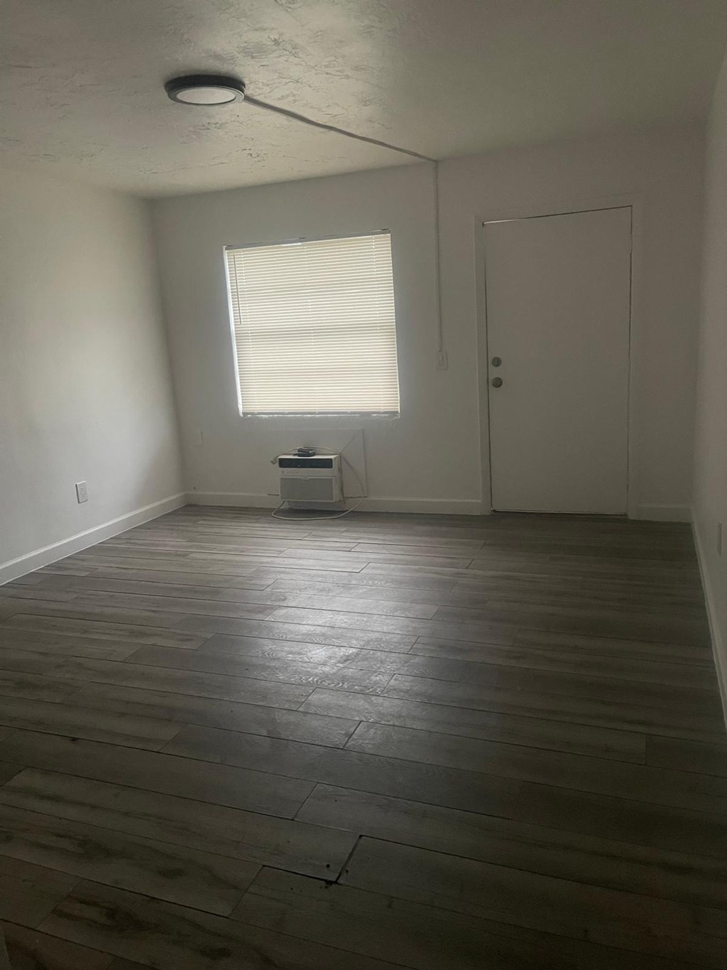 A room with a window and a door.