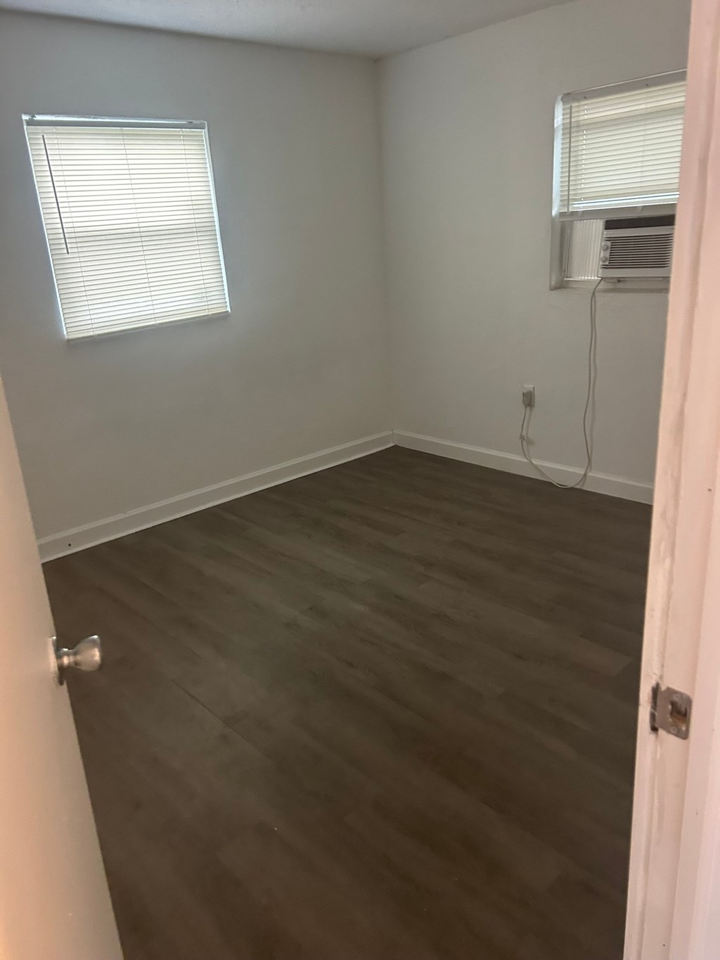 A room with a window and a door.