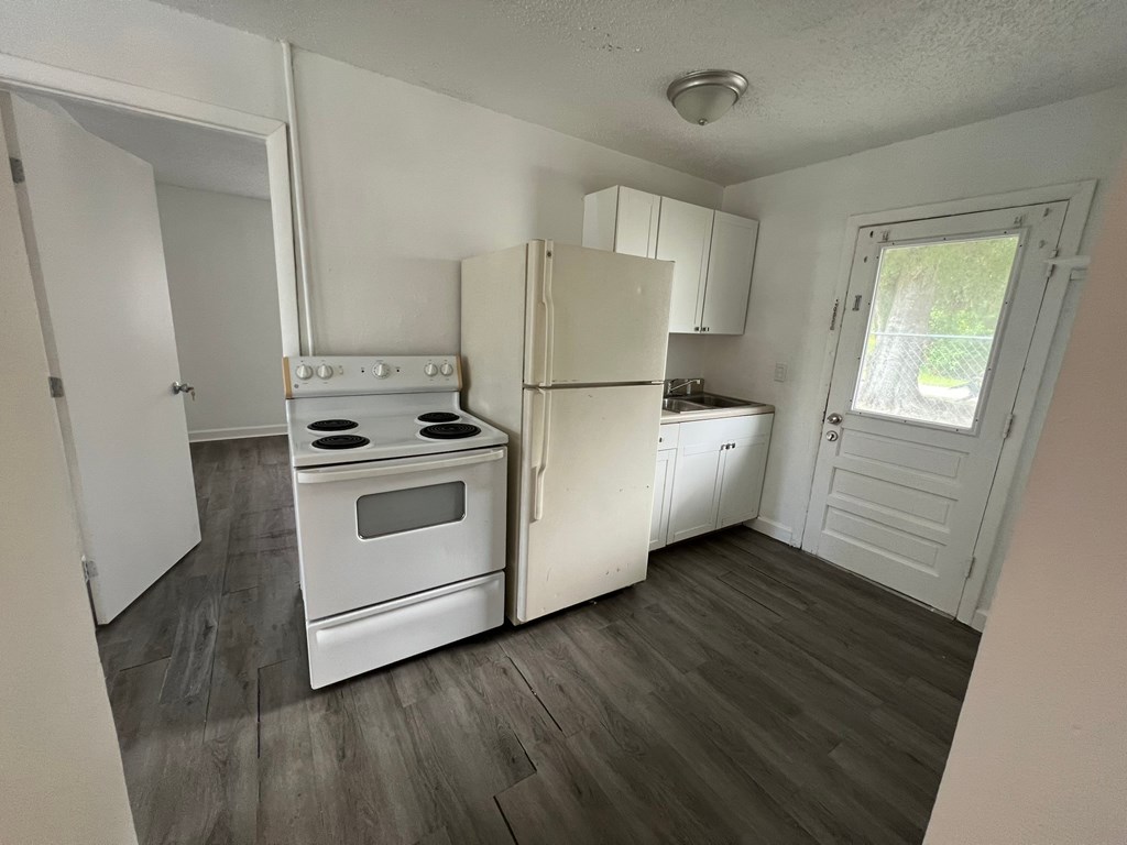 A kitchen with a white stove and oven.