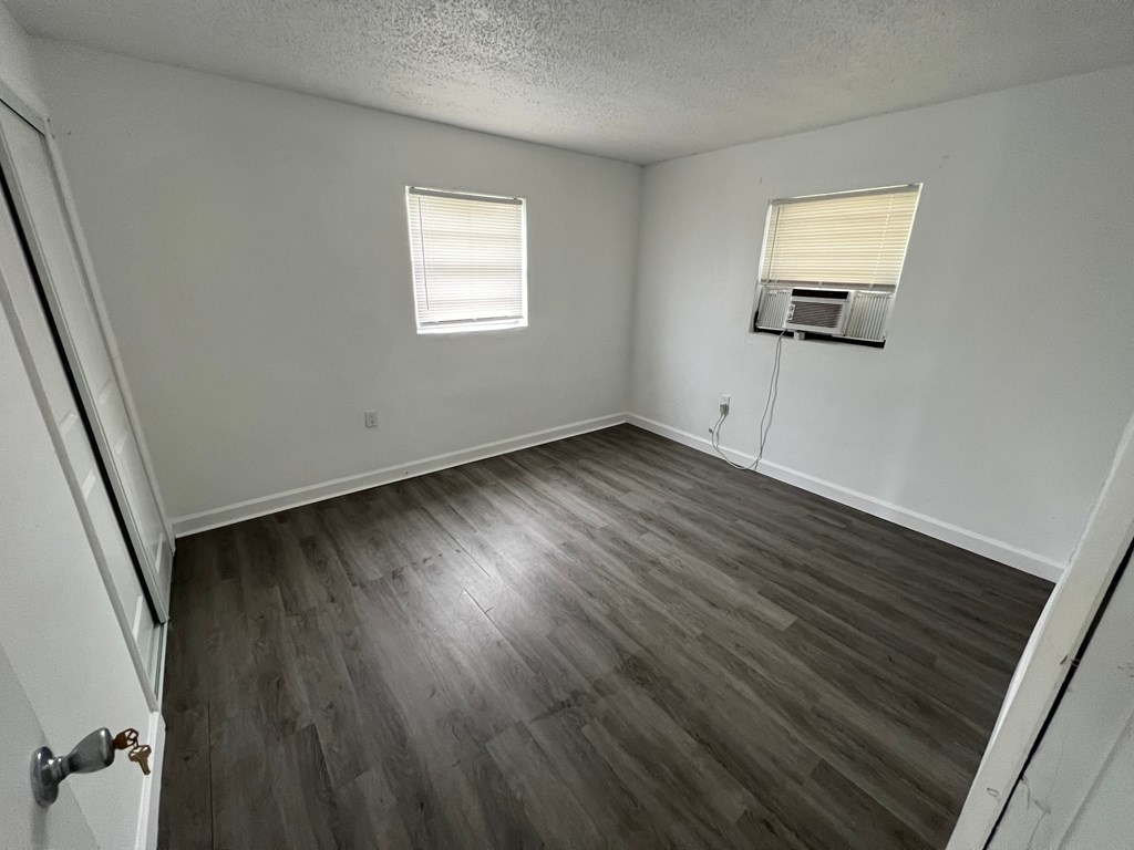 A room with a window and a door.