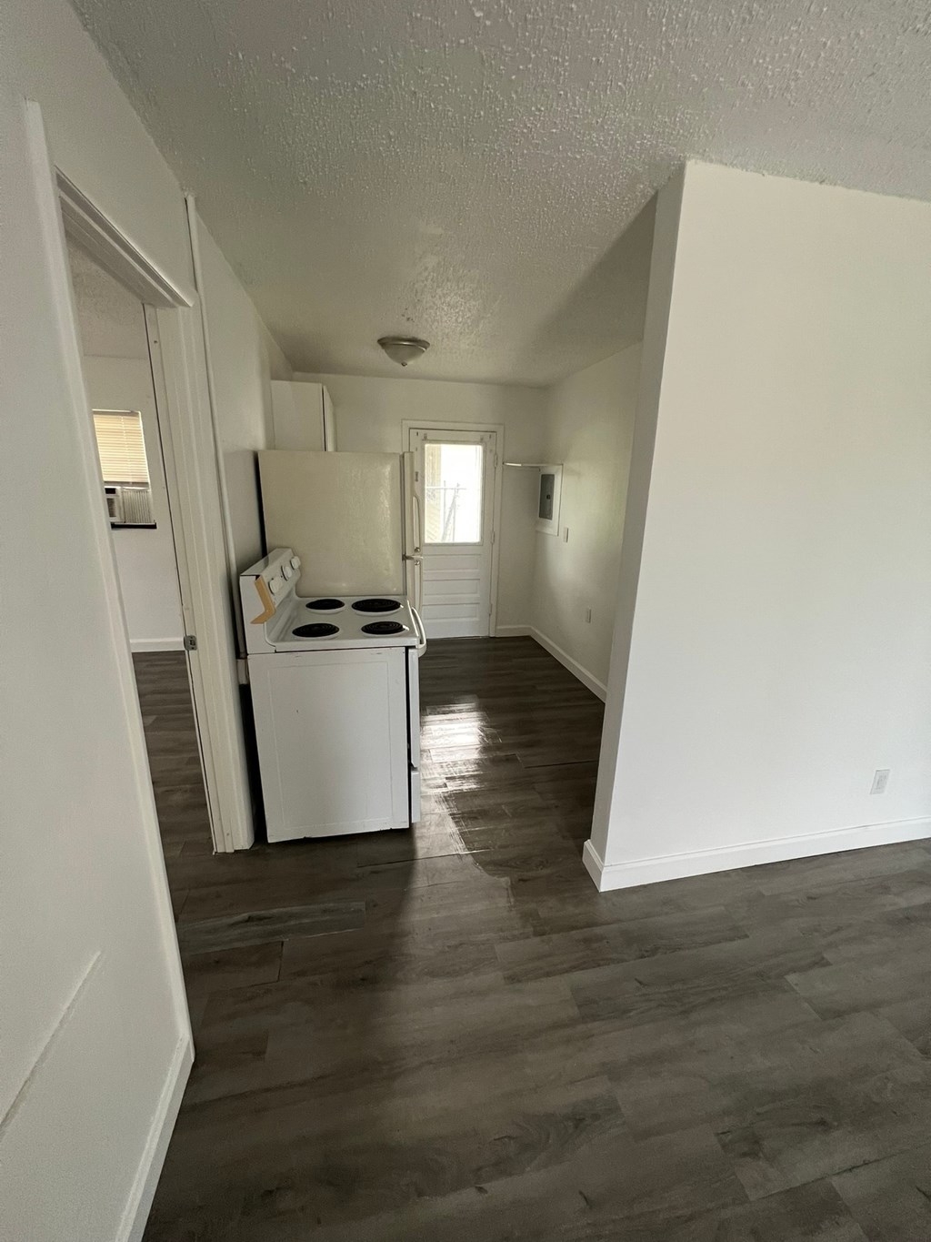 A white washer and dryer in a room with wood floors.