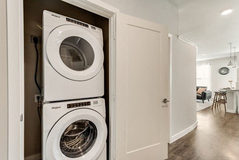 a front loading washer and dryer in a closet in a living room