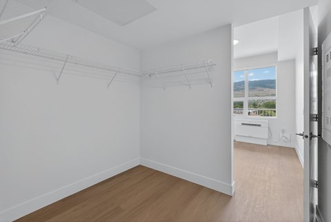 A white room with a sliding door leading to a balcony.