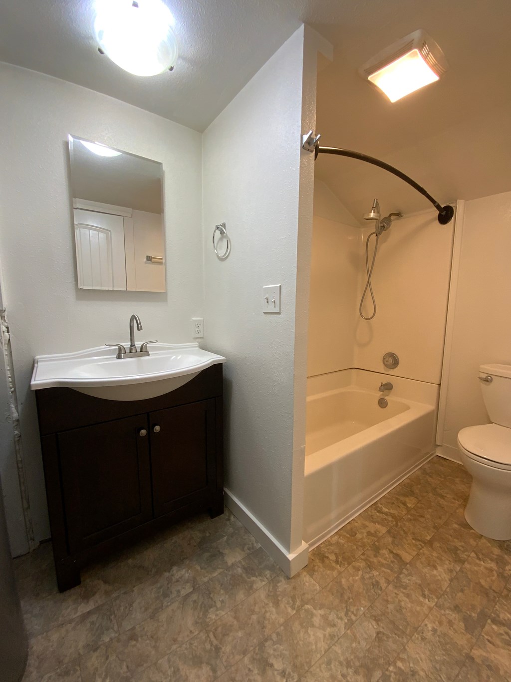 A bathroom with a sink, toilet, and bathtub.