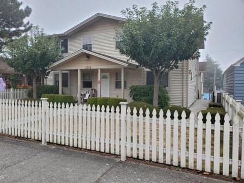 a white picket fence in front of a house