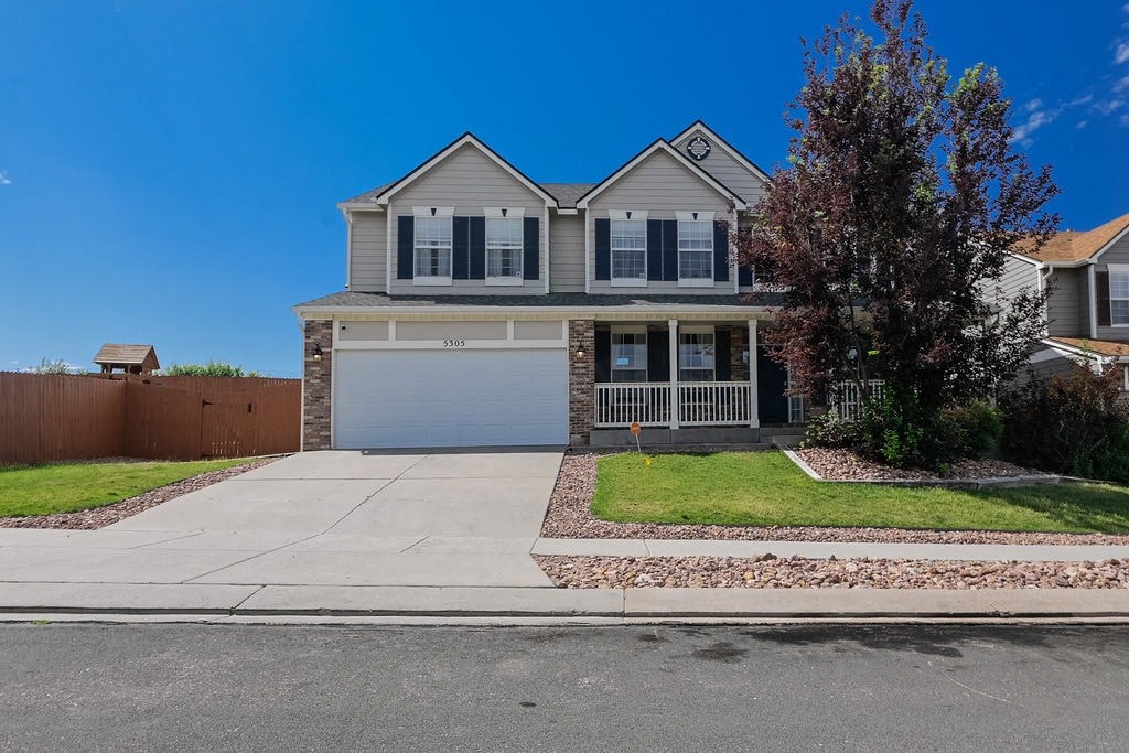 a house with a garage and a driveway in front of it