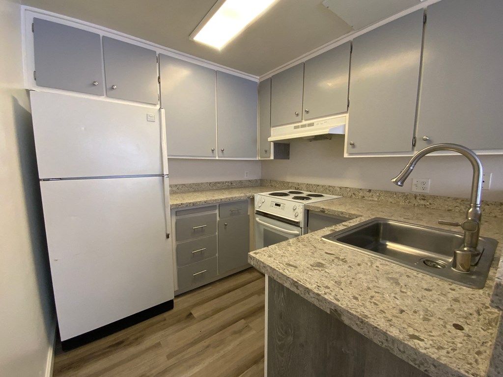 a kitchen with stainless steel appliances and granite counter tops