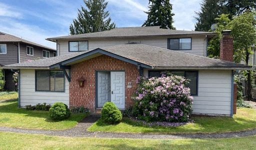 a house with a flowering in front of it