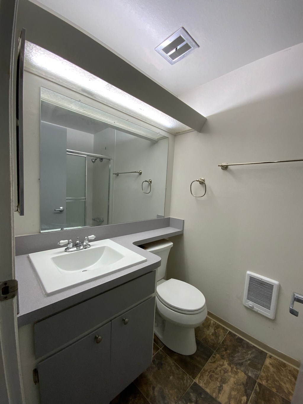 a bathroom with a sink toilet and a mirror