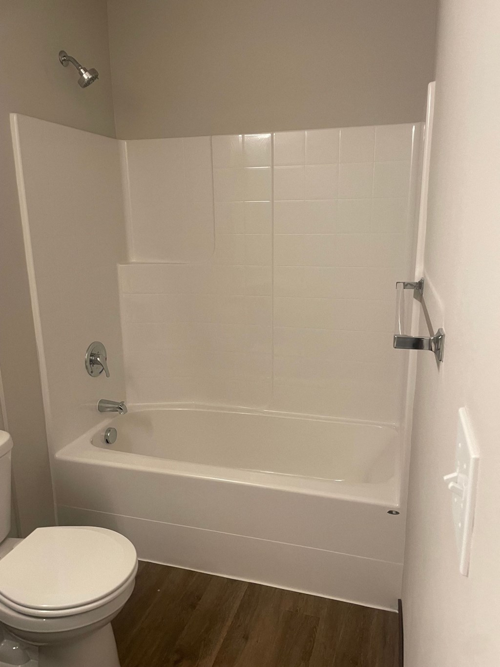 a white bathroom with a toilet and a tub