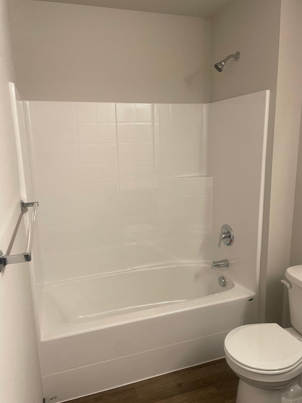 a white bathroom with a tub and a toilet