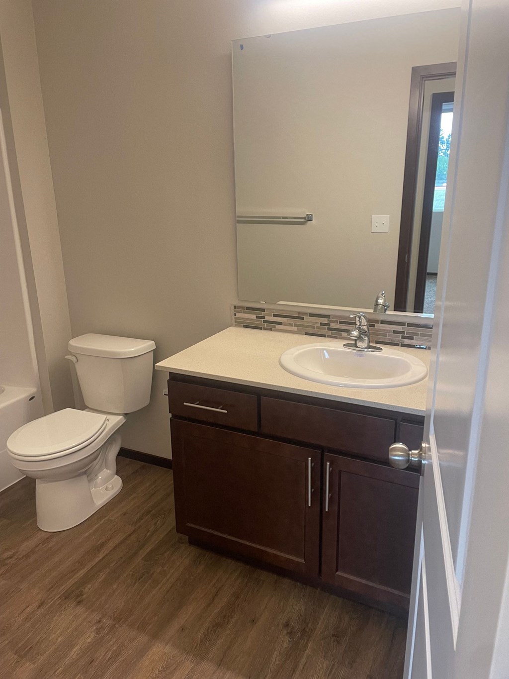 a bathroom with a sink toilet and a mirror