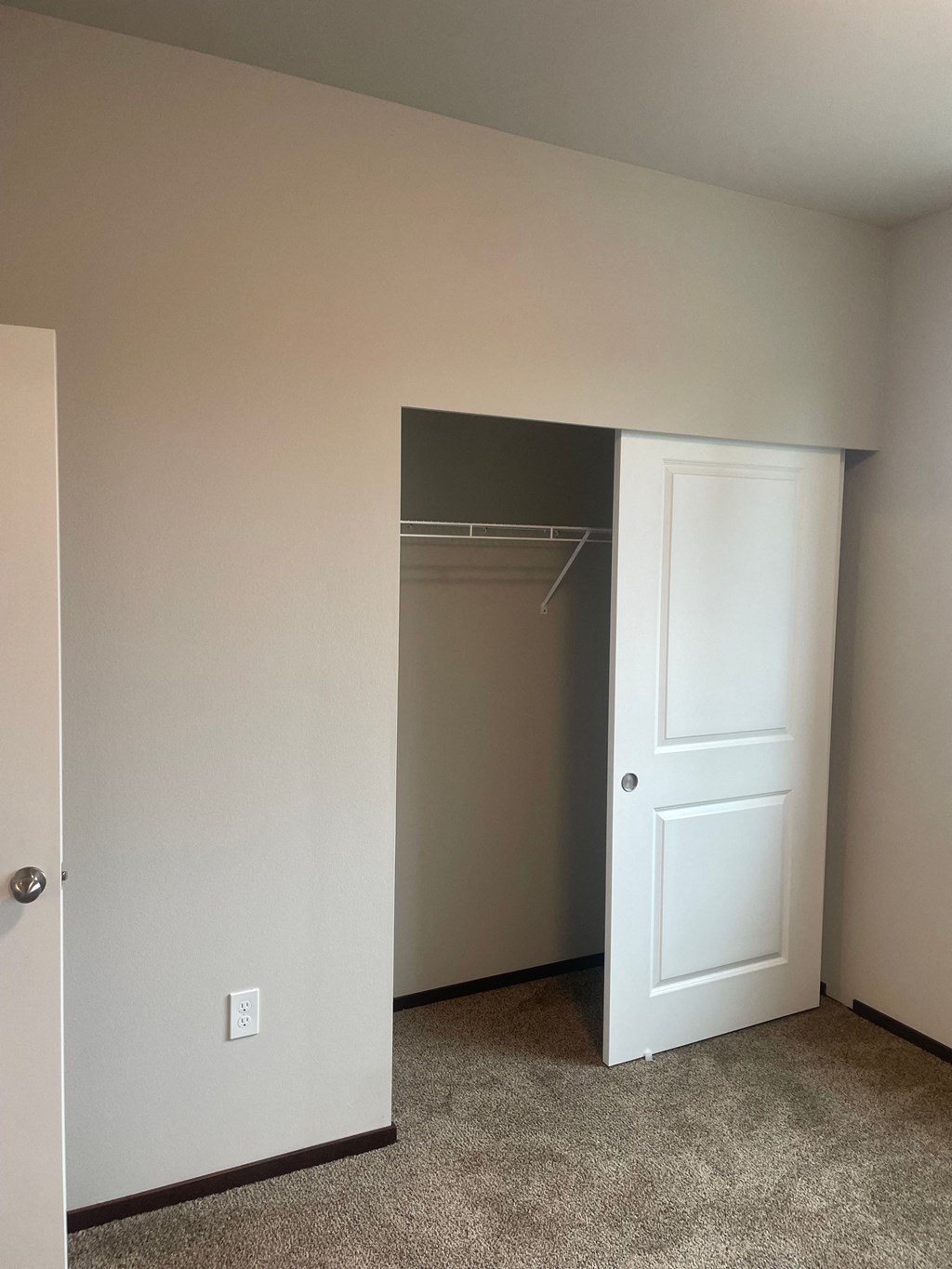 a room with a closet and an open door