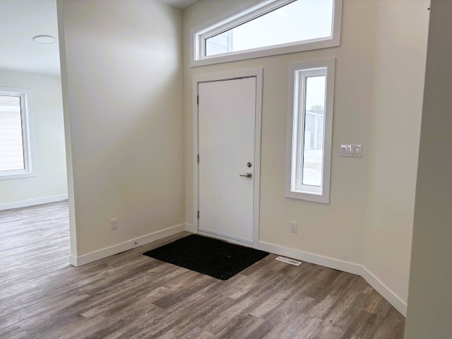 A room with a white door and a window.