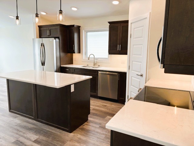 A kitchen with a white countertop and black cabinets.
