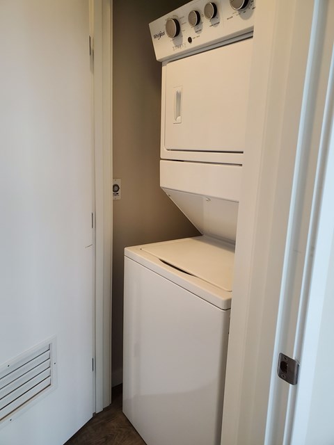 A white dishwasher and oven in a small kitchen.