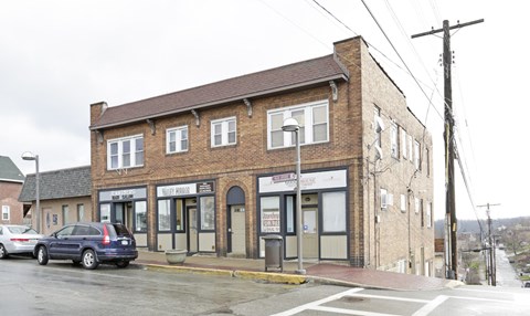 a small brick building on the corner of a city street
