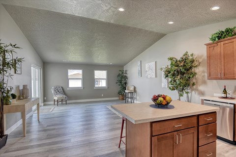 A kitchen with wooden cabinets and a large island.