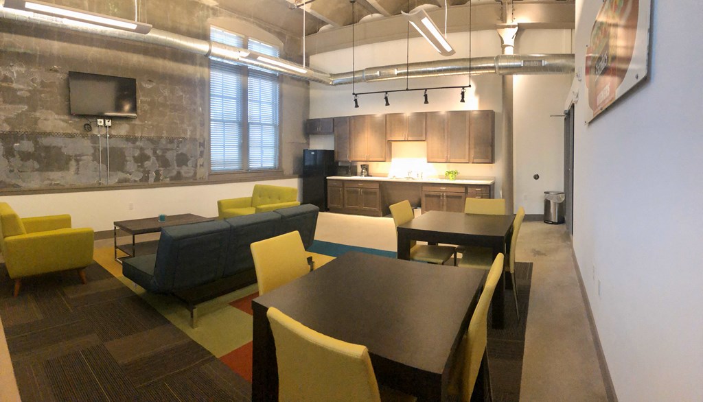 A room with a long table and chairs.