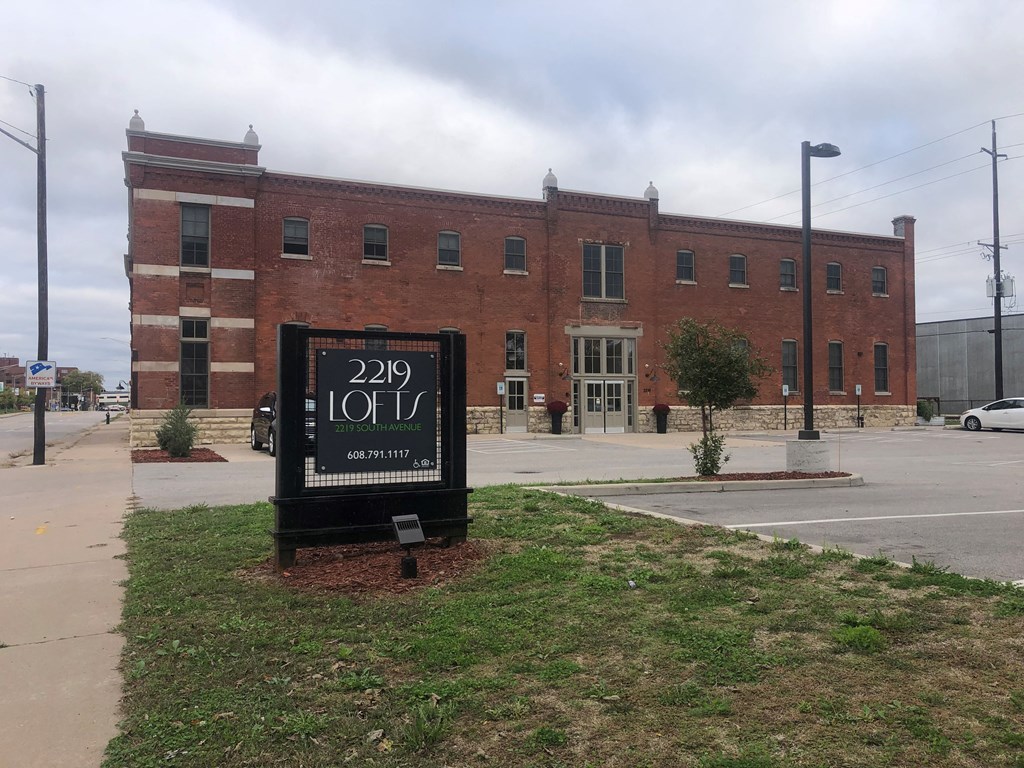 A brick building with a sign that says 2219 Lofts.