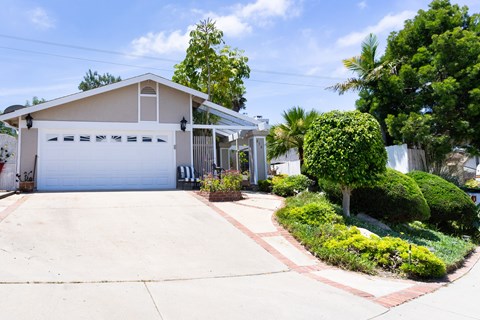 A house with a white garage door and a driveway.