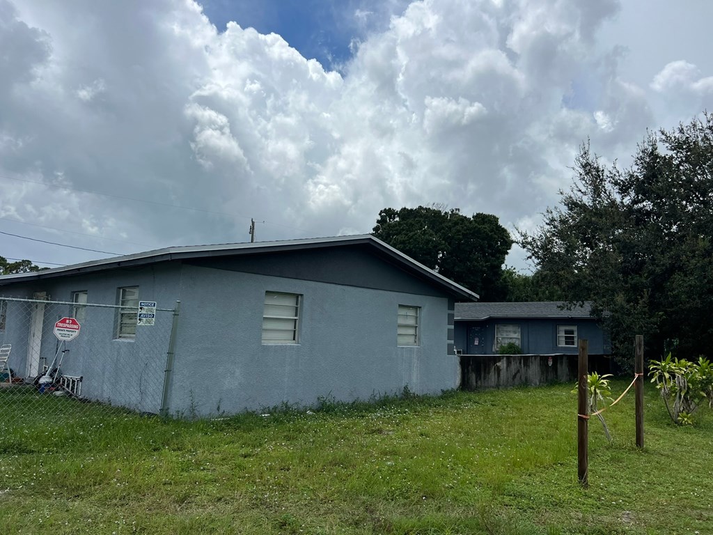 A blue house with a sign on the front.