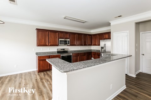 a kitchen with granite counter tops and wooden cabinets
