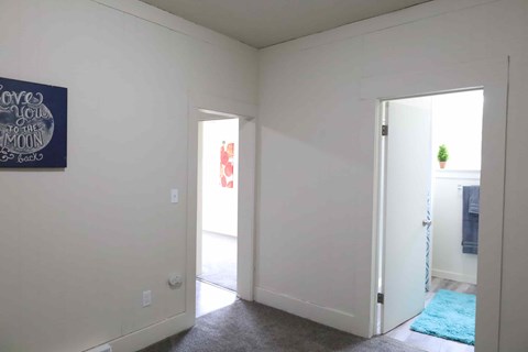 A room with a sign that says "Love you to the moon and back" on the wall.