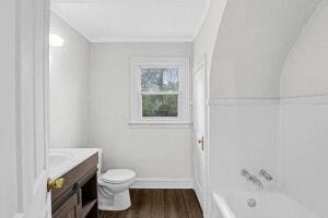 a bathroom with a toilet and a tub and a sink