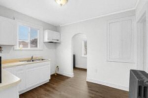 a kitchen with white cabinets and a sink