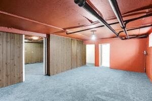 an empty room with wood paneled walls and an empty floor