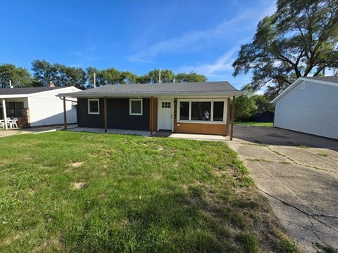 a home with a driveway and a lawn