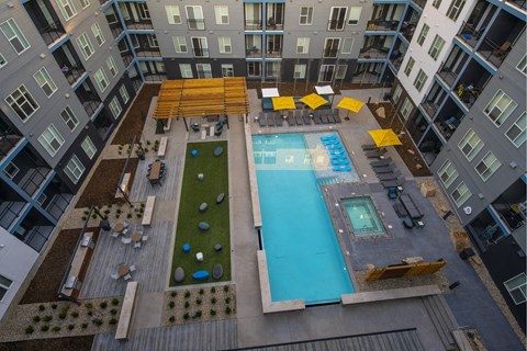 an overhead view of an apartment building with a swimming pool